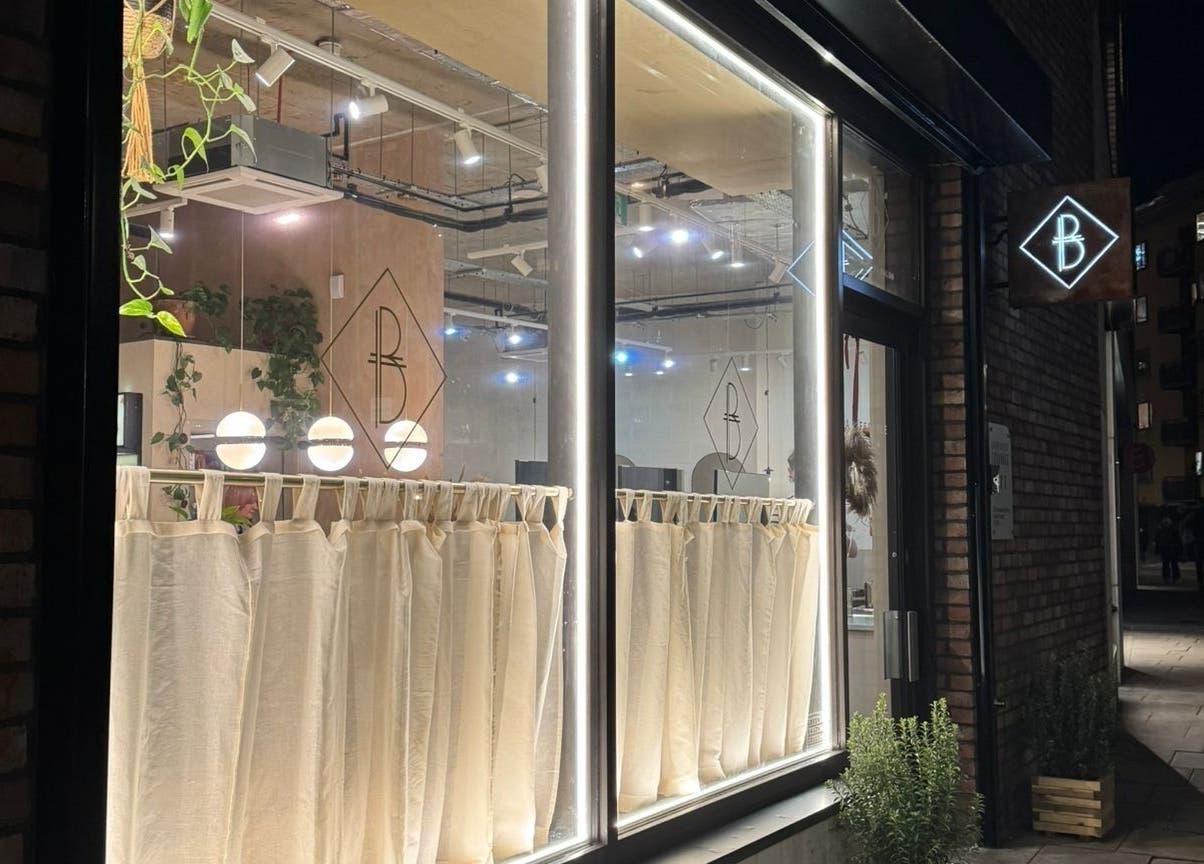 The Holistic Project's illuminated exterior at night in London, England, GB showcasing modern elegance.