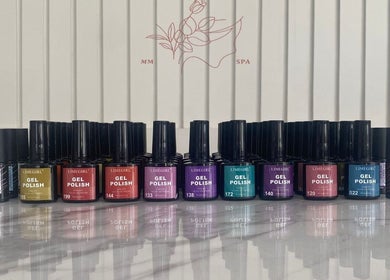 Colorful nail polish bottles at MMSPA - Home Service, Riyadh, SA for luxurious nail care.