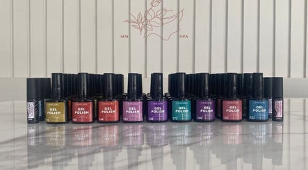 Colorful nail polish bottles at MMSPA - Home Service, Riyadh, SA for luxurious nail care.