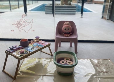 Relaxing spa setup at MMSPA - Home Service, Riyadh, SA with toys, books, and a foot bath.