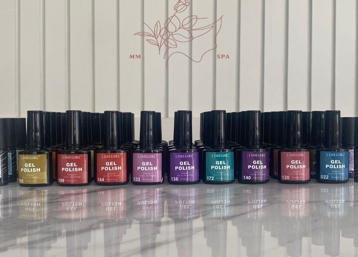 Colorful array of gel polish bottles at MMSPA - Home Service, Riyadh, SA, enhancing aesthetic beauty.