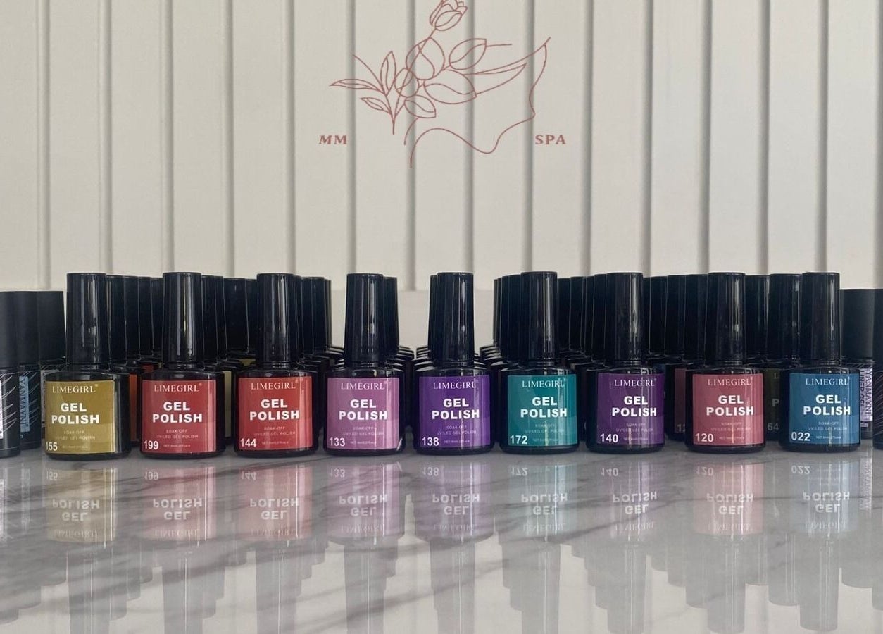Colorful array of gel polish bottles at MMSPA - Home Service, Riyadh, SA, enhancing aesthetic beauty.
