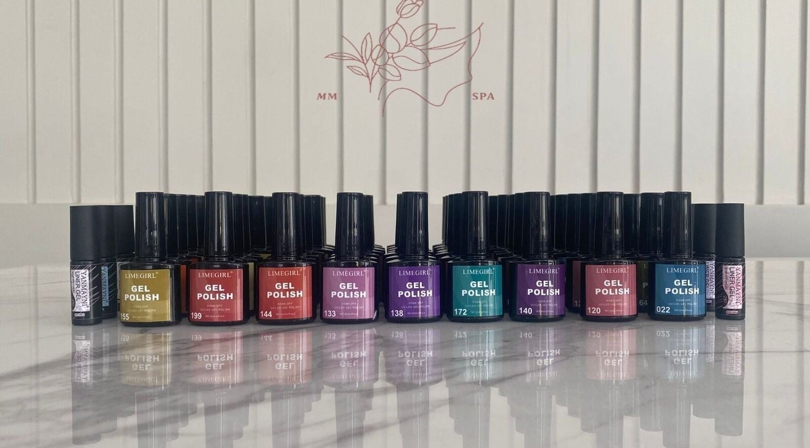 Colorful array of gel polish bottles at MMSPA - Home Service, Riyadh, SA, enhancing aesthetic beauty.