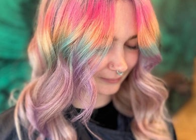 Vibrant rainbow hair styled at Bleach Brat, Ellon, Scotland, GB, showcasing pastel hues in a serene setting.