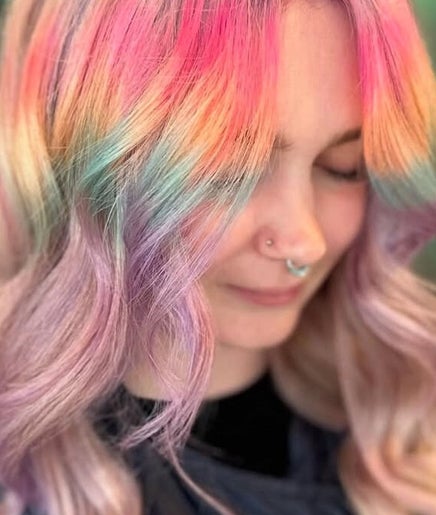 Vibrant rainbow hair styled at Bleach Brat, Ellon, Scotland, GB, showcasing pastel hues in a serene setting.