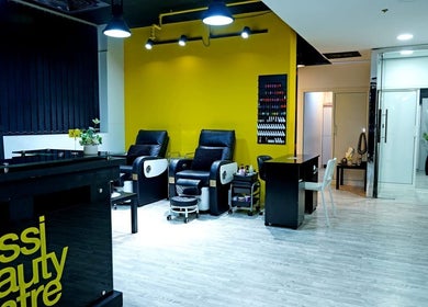 Modern interior of Sossi Beauty Center spa lounge in Abu Dhabi, AE with sleek chairs and vibrant decor.