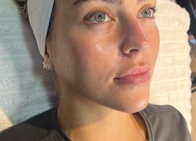 Woman receiving facial treatment at 7blessingsbeauty, Liverpool, England, GB for a glowing complexion.