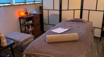 Relaxing massage room at Bow-tiful in Hoyland, England with ambient lighting and comfortable furnishings.