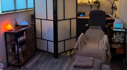 Relaxing treatment room at Bow-tiful, Hoyland, England, GB with a cozy chair and tranquil lighting.