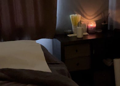 Cozy treatment room at The Beauty Vault, Liversedge, England, GB with candles and soft lighting.