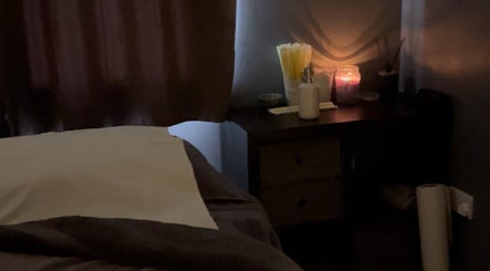 Cozy treatment room at The Beauty Vault, Liversedge, England, GB with candles and soft lighting.