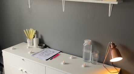 Cozy beauty setup at The Beauty Vault, Liversedge, England. Relaxing ambiance with candles and calming decor.