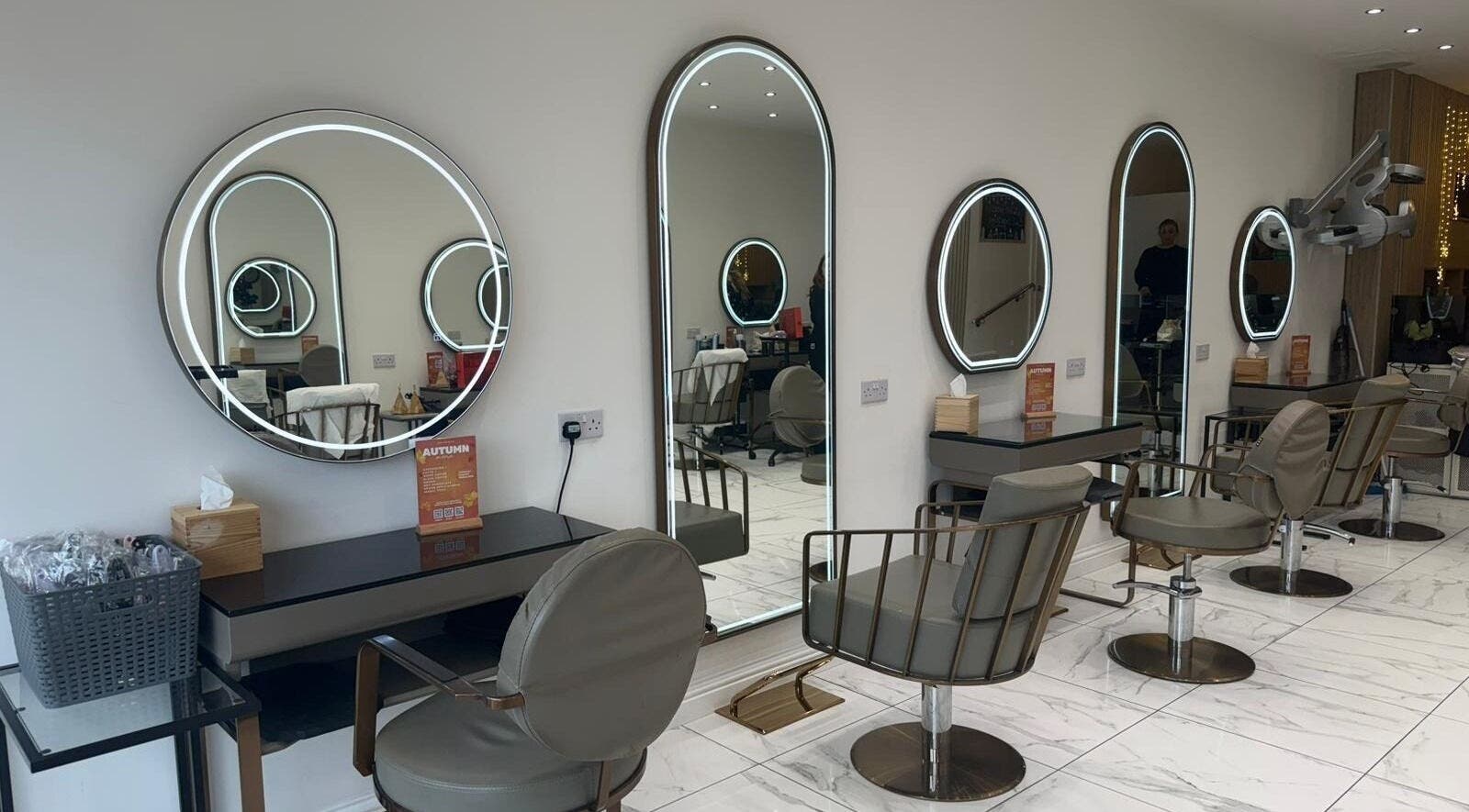 Modern salon interior at Bliss And Bliss Hair, Stourbridge, England, GB, showcasing stylish mirrored stations.