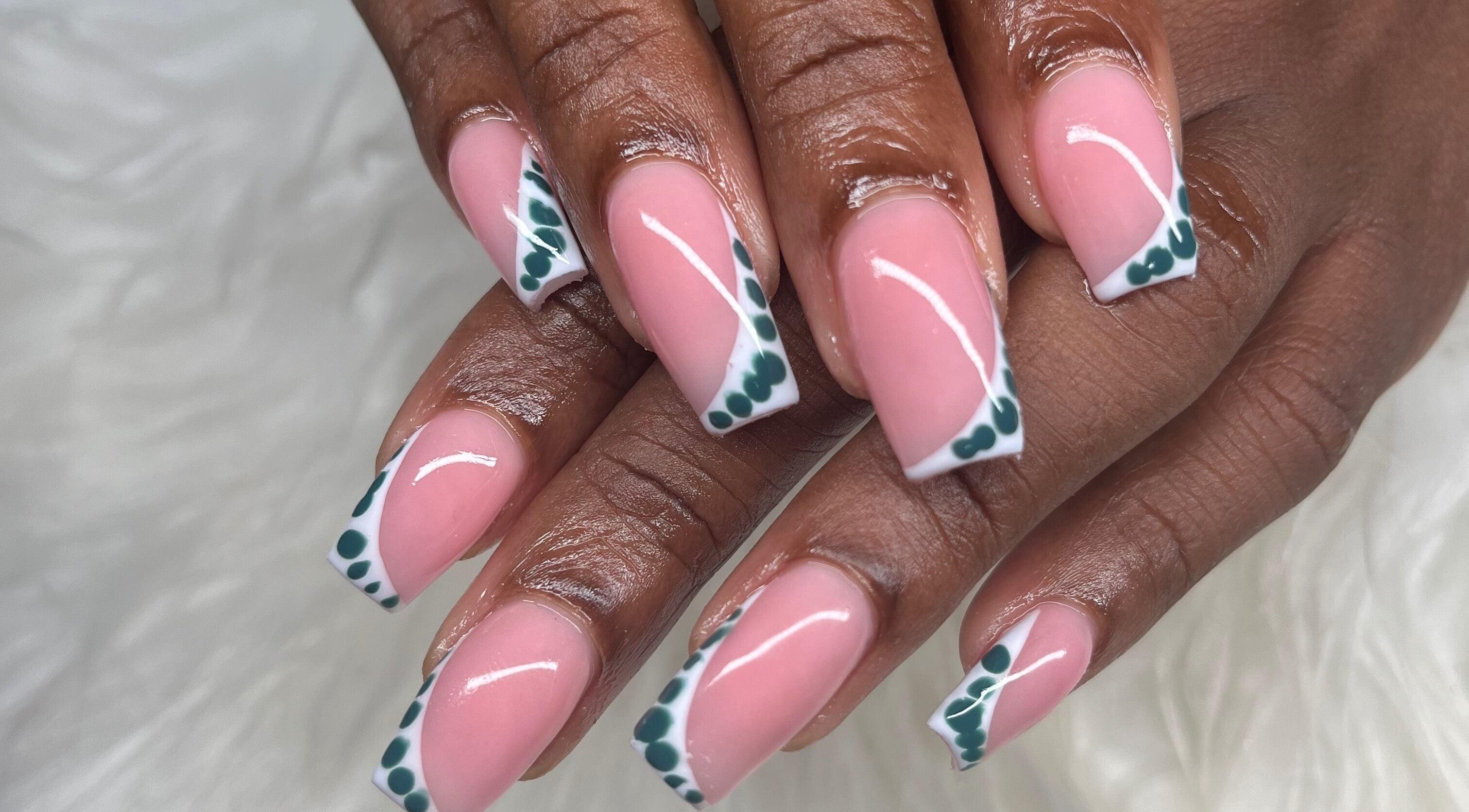 Stylish nail art with pink polish and green accents at Buffed246, Lancaster, Saint James, BB.