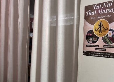 Interior view of Tui Nui Thai Massage in Bowden, South Australia, showcasing a calming massage room with curtains.