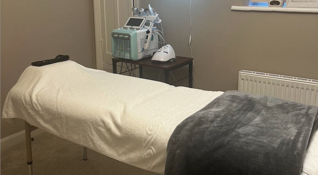 Cozy treatment room at Facelism in Croydon, England, GB. Featuring a massage bed and beauty equipment.