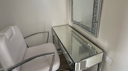 Chic makeup station at Amelia Rose Studio in Bracknell, England, GB with elegant mirrored desk and comfy chair.