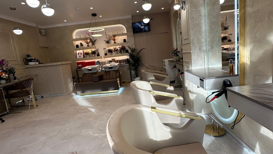 Stylish interior of Roza Hair Saloon in London, England, GB showcasing modern design and comfortable styling chairs.