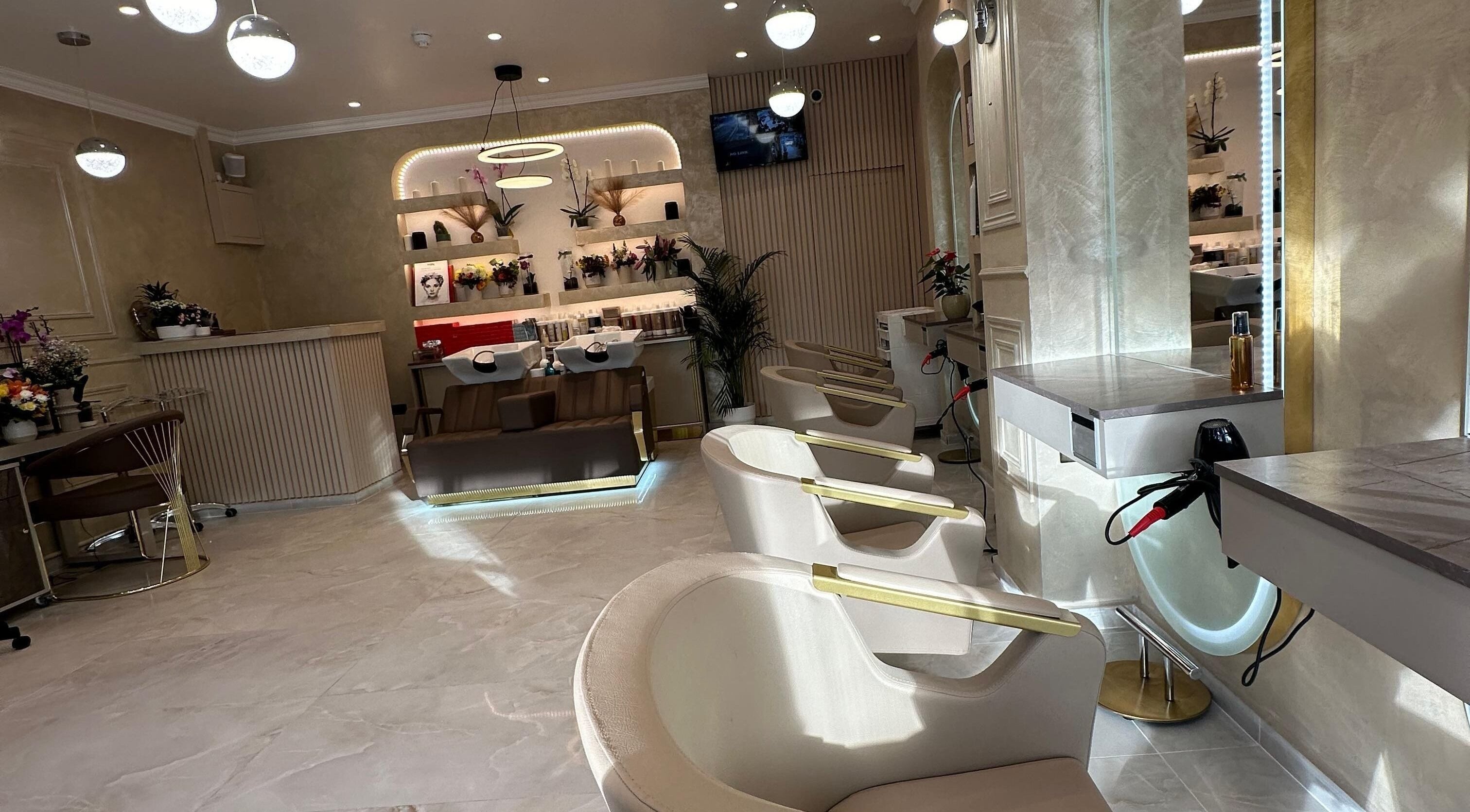 Stylish interior of Roza Hair Saloon in London, England, GB showcasing modern design and comfortable styling chairs.