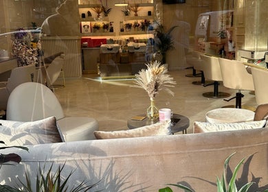 Chic interior of Roza Hair Saloon in London, England, GB with stylish seating and decor.
