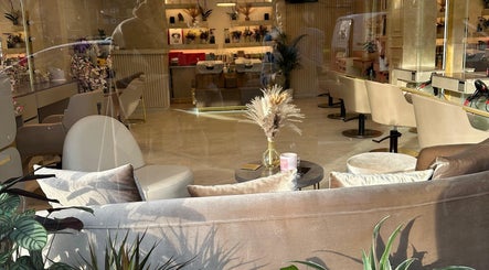 Chic interior of Roza Hair Saloon in London, England, GB with stylish seating and decor.