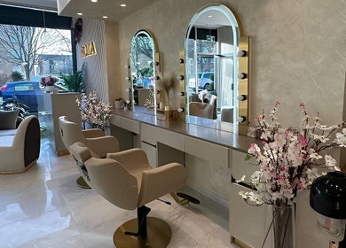 Interior view of Roza Hair Saloon in London, England, GB showcasing stylish mirrors and seating.
