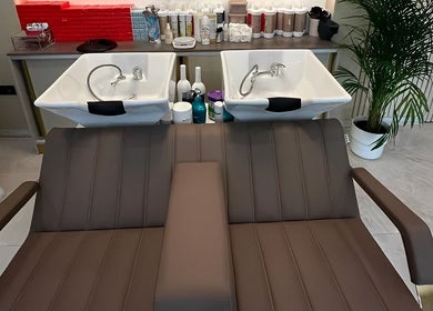 Modern wash stations at Roza Hair Saloon in London, England, GB, showcasing elegance and functionality.