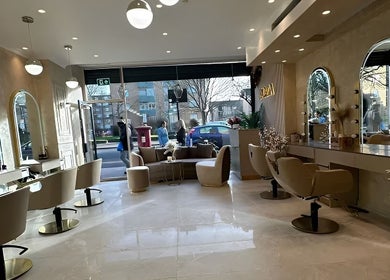 Modern interior of Roza Hair Saloon in London, England, GB with stylish chairs and mirrors.