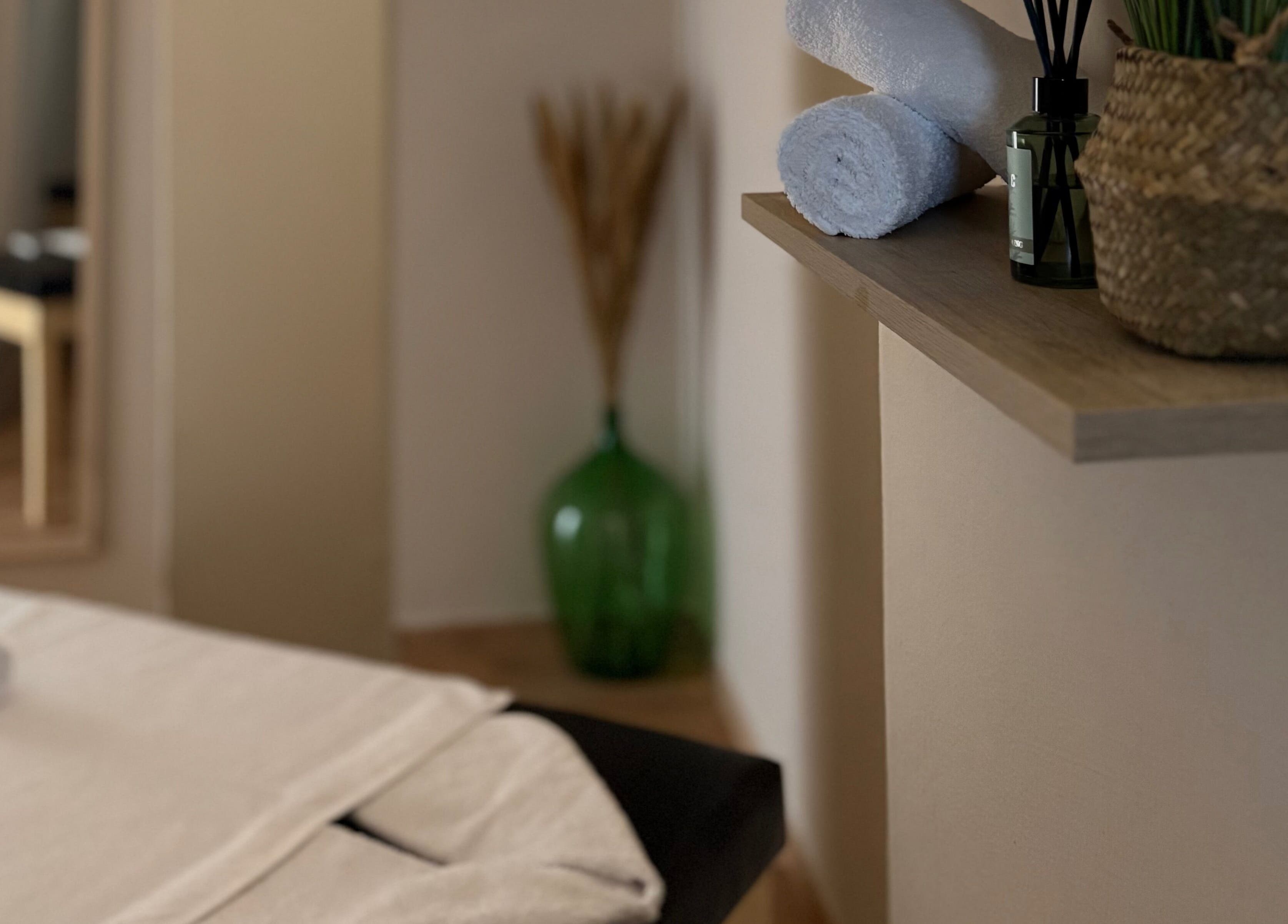 Χαλαρωτικός χώρος στο Serenity Massage Experience, Λάρισα, GR, με πετσέτες και αρωματικά.