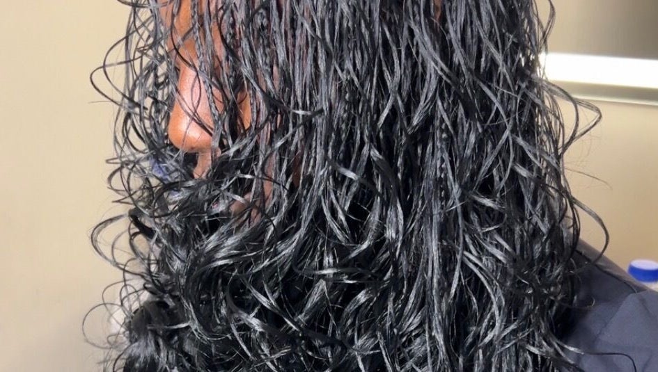 Close-up of shiny, wet curls styled at Olutey in Toronto, Ontario, CA, showcasing sleek and healthy hair.