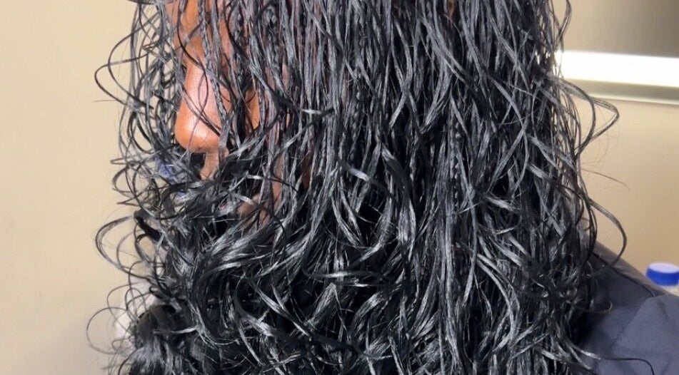 Close-up of shiny, wet curls styled at Olutey in Toronto, Ontario, CA, showcasing sleek and healthy hair.