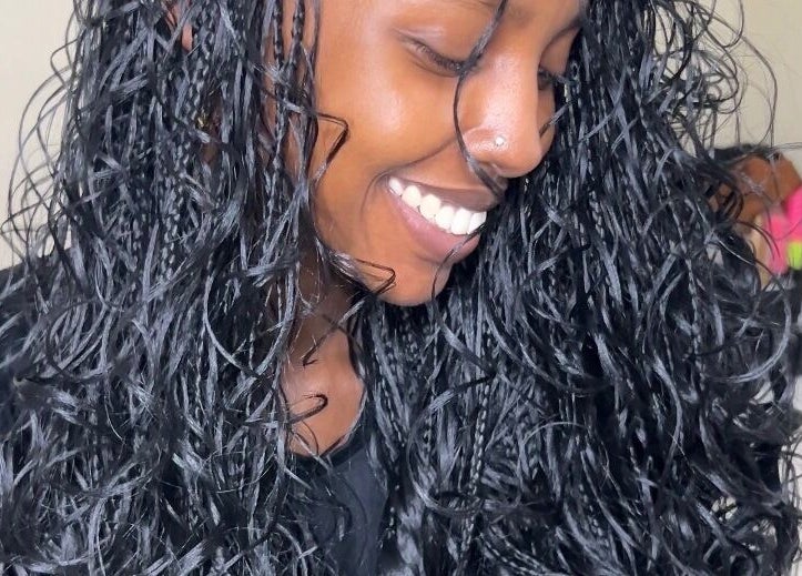 Woman's radiant, curly hair styled at Olutey in Toronto, Ontario, CA.