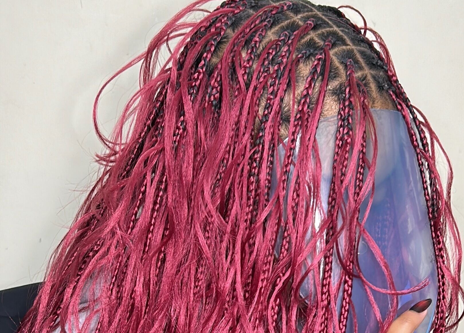 Bold pink braids hairstyle at Olutey in Toronto, Ontario, CA showcasing intricate artistry and vibrant color.