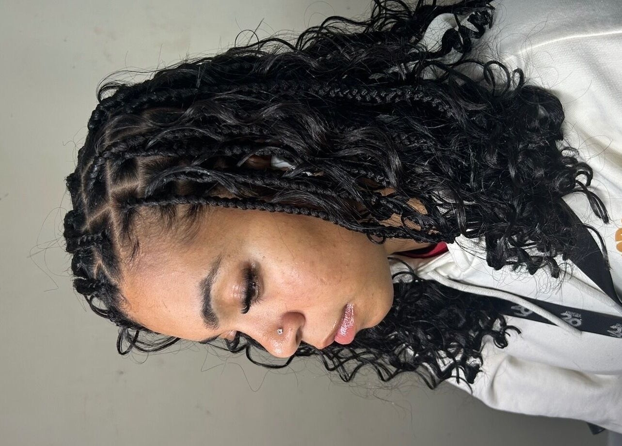 Intricate braided hairstyle at Olutey in Toronto, Ontario, CA showcasing detailed curl patterns.