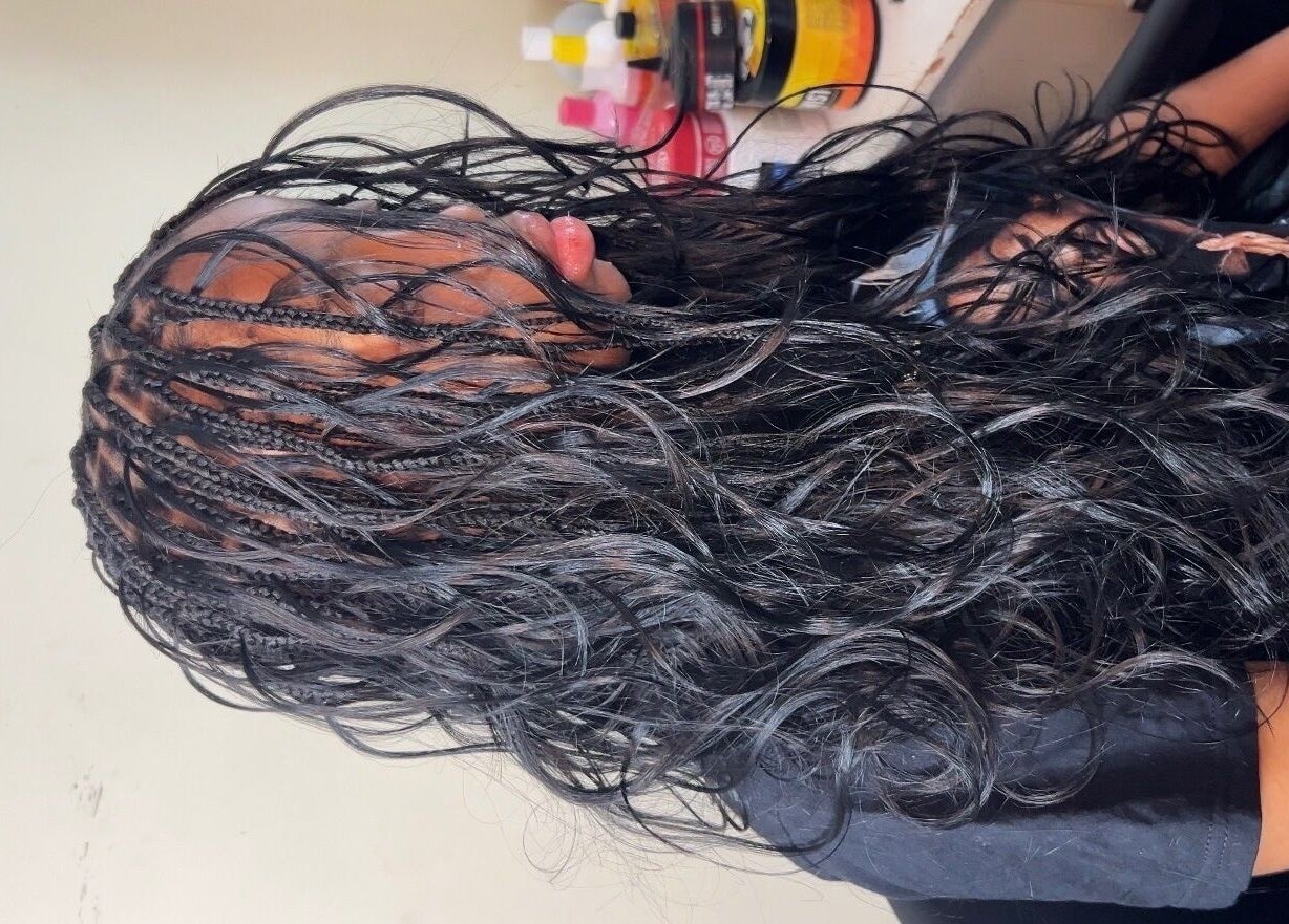 Intricate braided hairstyle at Olutey, Toronto, Ontario, CA showcasing glossy black hair.