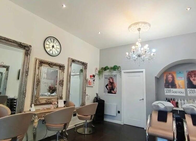 Chic salon interior at Williamsoncuts, Dunfermline, Scotland, GB, showcasing ornate mirrors and modern styling chairs.