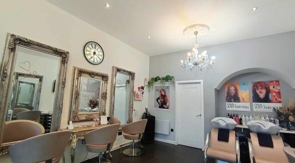 Chic salon interior at Williamsoncuts, Dunfermline, Scotland, GB, showcasing ornate mirrors and modern styling chairs.