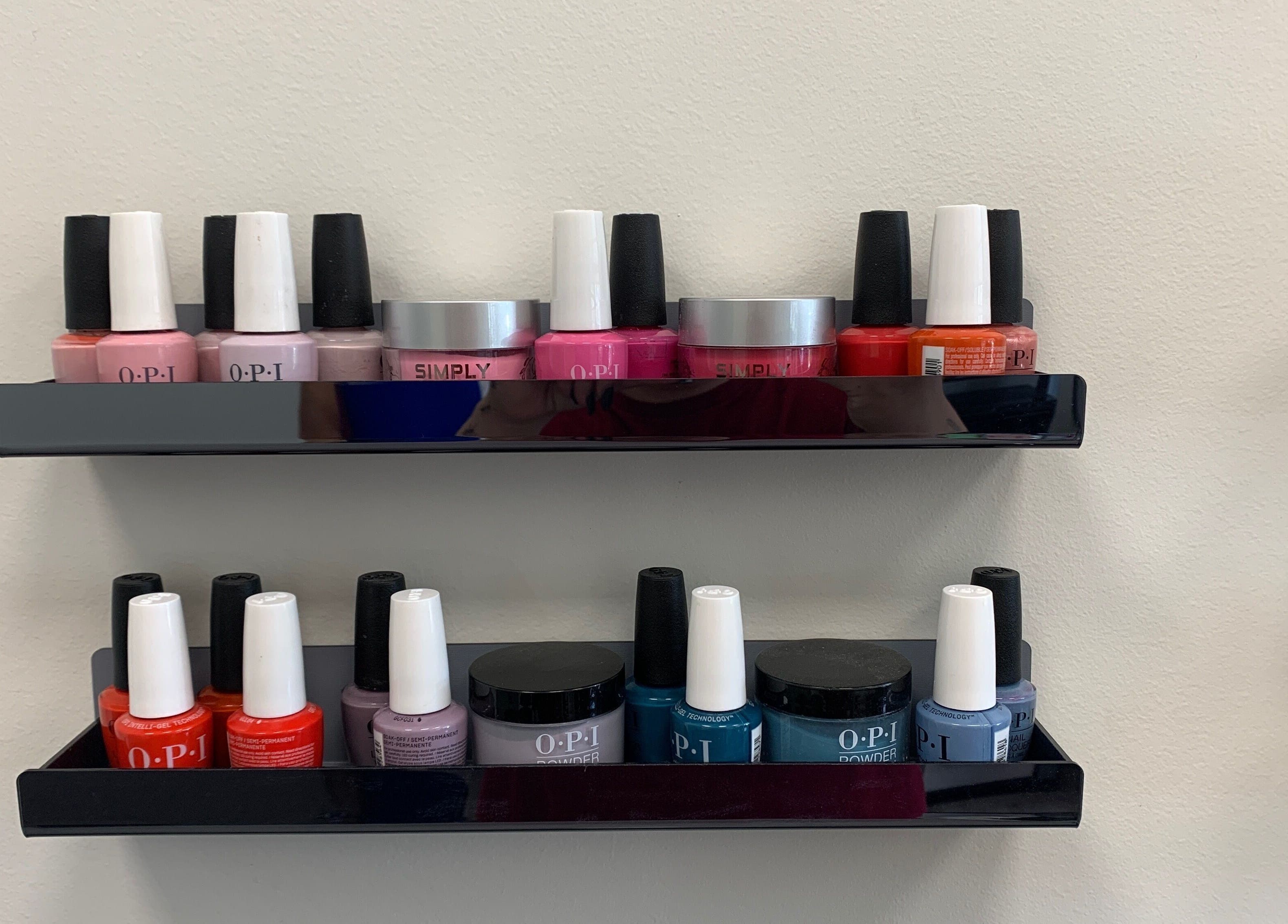 Nail polish display at Coco Nail Studio in Baton Rouge, Louisiana, US showcasing vibrant lacquer colors.