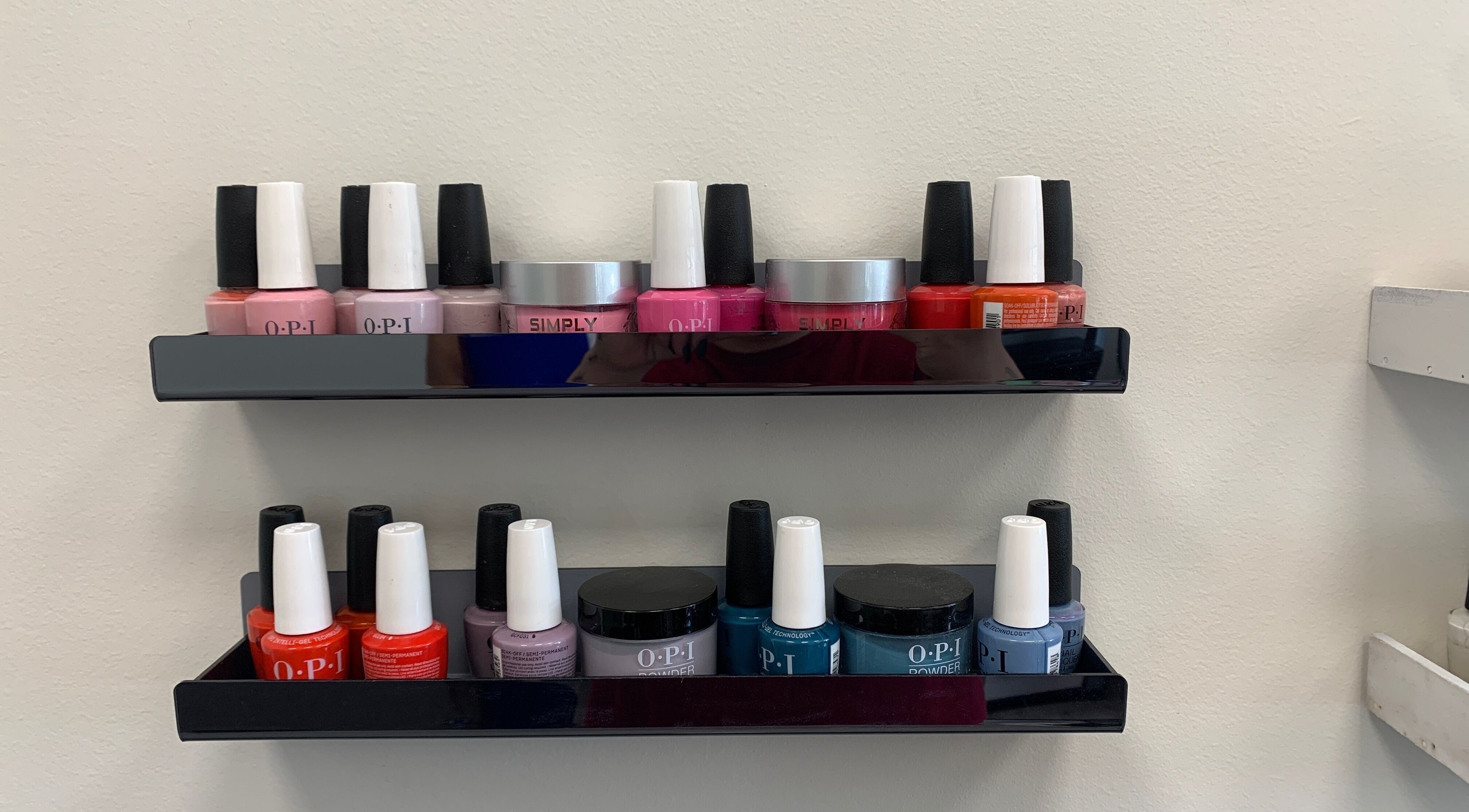 Nail polish display at Coco Nail Studio in Baton Rouge, Louisiana, US showcasing vibrant lacquer colors.