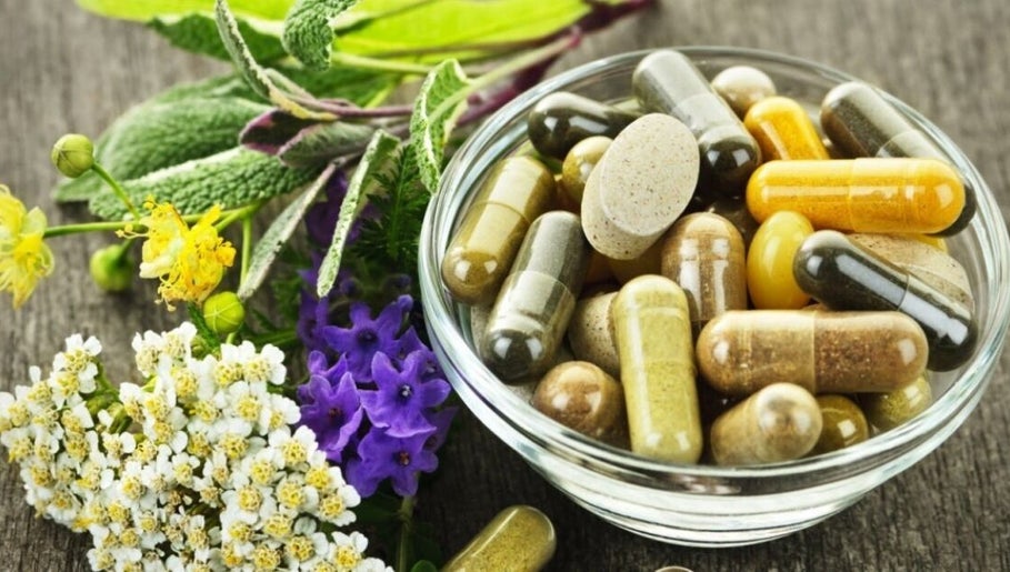 Herbal capsules and flowers in a bowl at KB Herbs, County Galway, County Galway, IE.