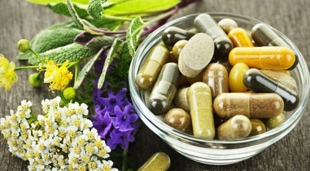 Herbal capsules and flowers in a bowl at KB Herbs, County Galway, County Galway, IE.