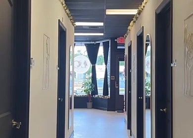 Elegant hallway at LC Beauty Bar, Apopka, Florida, US, with multiple rooms and natural lighting.