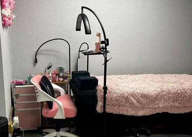 Stylish makeup setup at LC Beauty Bar, Apopka, Florida, US with pink chair and plush blanket.