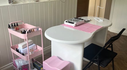 Chic nail station at beautybymia, Nettleham, England, GB. Features modern table and pink storage cart.