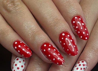 Stylish red and white polka dot nails at beautybymia in Nettleham, England, GB.