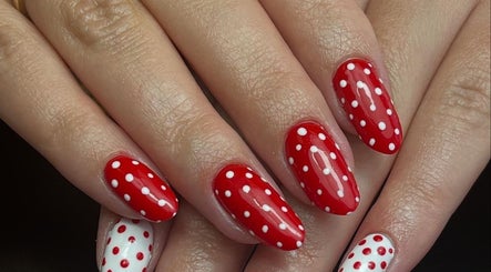 Stylish red and white polka dot nails at beautybymia in Nettleham, England, GB.