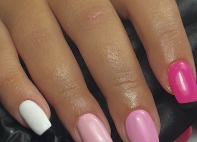 Colorful manicured nails in pink and white at beautybymia, Nettleham, England, GB.