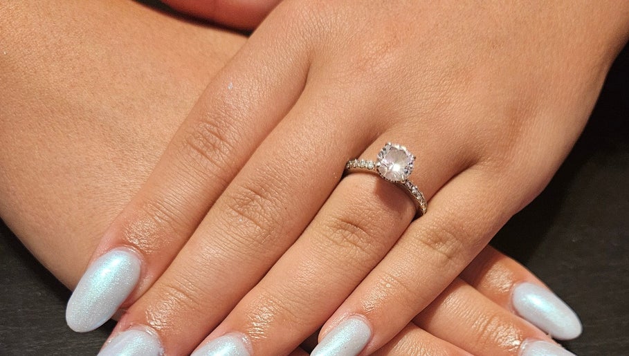 Elegant pearl nails with a sparkling ring at Nailed it Nails, Waupun, Wisconsin, US.