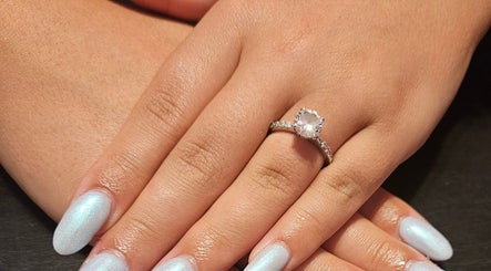 Elegant pearl nails with a sparkling ring at Nailed it Nails, Waupun, Wisconsin, US.