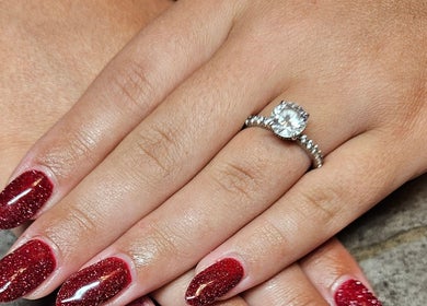 Elegant red sparkly nails with ring at Nailed it Nails, Waupun, Wisconsin, US.